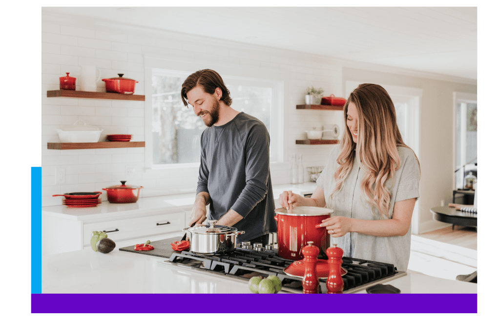 Seller and buyer reviewing property information in a kitchen