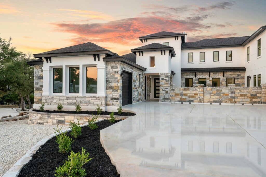 Luxury stone-and-stucco home at sunset